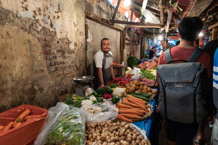 Tangerang, Indonesia - July 22, 2018: Vegetable seller in a small lane within traditional market, Pasar Lama.のeditorial素材