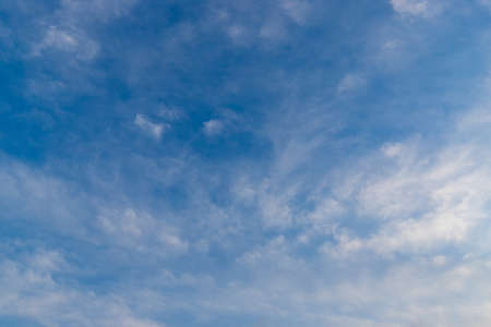 Blue sky with scattered clouds.の写真素材