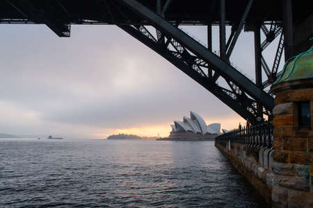 Sydney, Australia - November 5, 2018: Sydney Opera house view under the Harbour Bridge with foggy warm light.のeditorial素材
