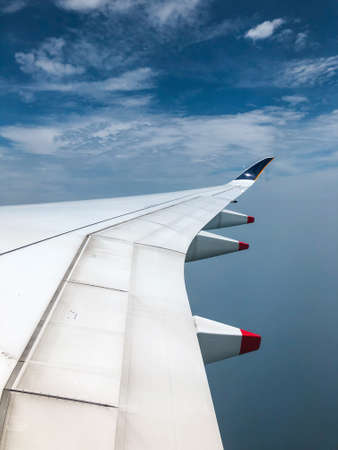 aircraft wings in a blue sky.の写真素材