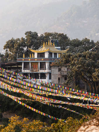Kathmandu, Nepal - December 6, 2018: Colorful flags with golden pagoda at Swayambhunath temple.のeditorial素材