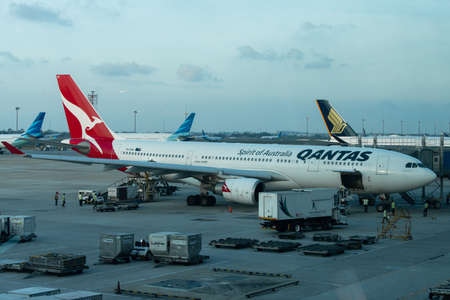 Jakarta, Indonesia - January 7, 2019: Airport worker loading stuff into Qantas airplane at Soekarno Hatta International Airport terminal 3のeditorial素材