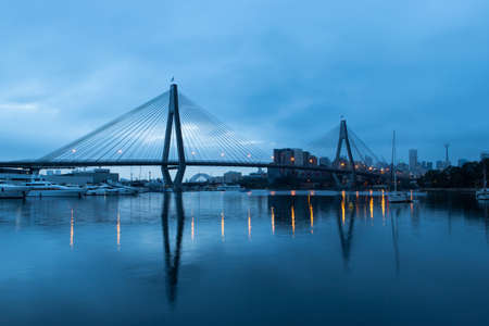 Sydney, Australia - March 9, 2019: Anzac bridge view with reflection on a cloudy dawn hour.のeditorial素材