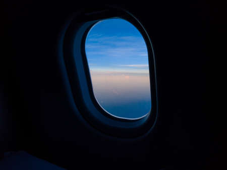 Blue sky view through the airplane window.