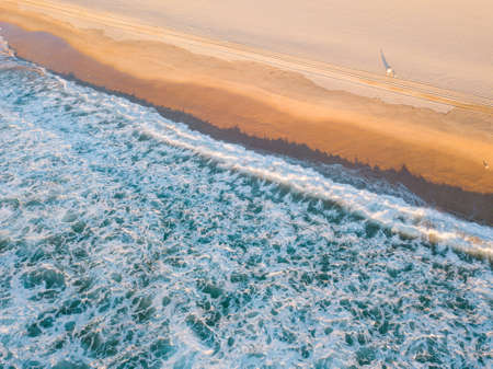 Aerial view of beach coastline with a lot of wave white foam.の写真素材