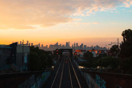 Melbourne, Australia - Melbourne CBD skyline with railroad track morning view with cloudy sky.