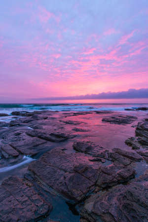 Rocky coastline view on a beautiful sunrise colour.