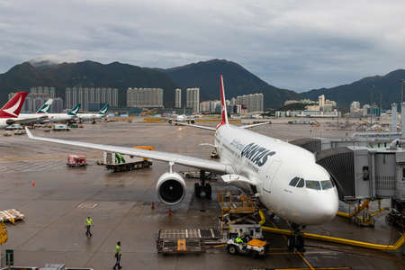 Hong Kong - October 6, 2019: Qantas Airbus 330 loading at Hong Kong International Airport.のeditorial素材