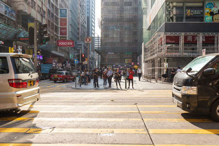 Hong Kong - October 3, 2019: People waiting to cross the road at Tsim Sha Tsui.のeditorial素材