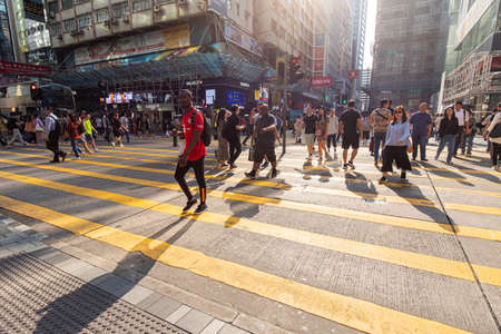 Hong Kong - October 3, 2019: Crowd of people crossing the road at Tsim Sha Tsui.のeditorial素材