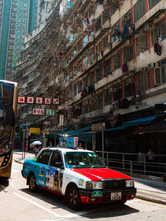 Hong Kong - October 4, 2019: Taxi stopping in front of a public housing.のeditorial素材