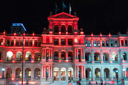 Brisbane, Australia - January 25, 2020: Brisbane Treasury Casino and Hotel at night light up with red colour.のeditorial素材