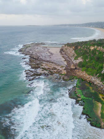 Aerial view of rocky coastline and Narrabeen headland in the morning.の写真素材