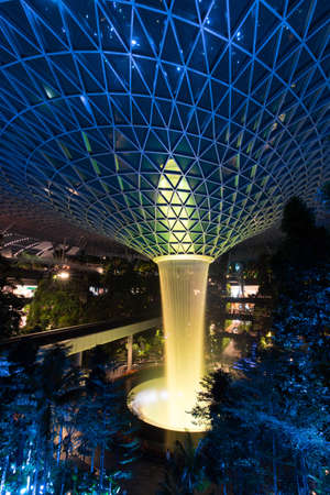 Singapore - February 6, 2020: Yellow lights up on the garden and rain vortex at Jewel Changi Airport.のeditorial素材