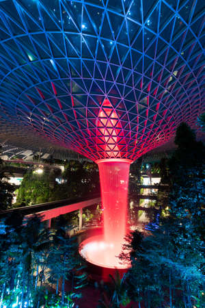 Singapore - February 6, 2020: Red lights up on the garden and rain vortex at Jewel Changi Airport.