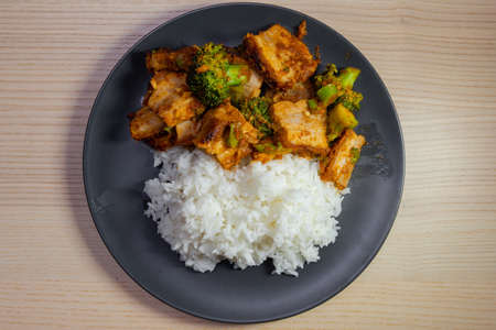 A plate of pad prik khing, thai red curry stir fried, with pork belly and white rice.の写真素材