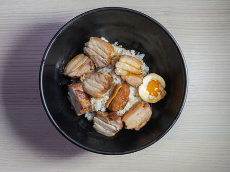 A bowl of kakuni, braised pork belly, on top of white rice.の写真素材