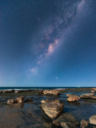 Milky way view over the rocky coastline of Coalcliff, NSW, Australia.の写真素材