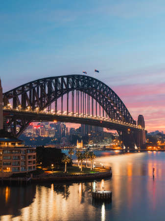 Sydney, Australia - June 7, 2020: Sydney Harbour Bridge and city skyline with colorful sky.のeditorial素材