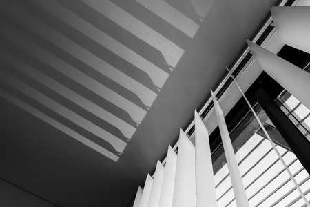 Window blinds and their shadow on the ceiling.の写真素材