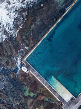 Top down view of ocean pool with rock on the side, Newcastle, Australia.の写真素材