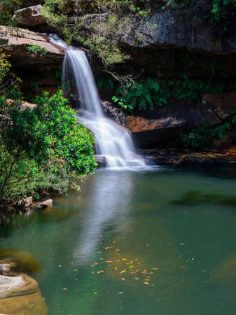 Bright sunlight over Upper Gledhill Falls, Sydney, Australia.