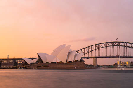 Sydney, Australia - November 21, 2020: Sunset view of Sydney Opera House with orange sky.