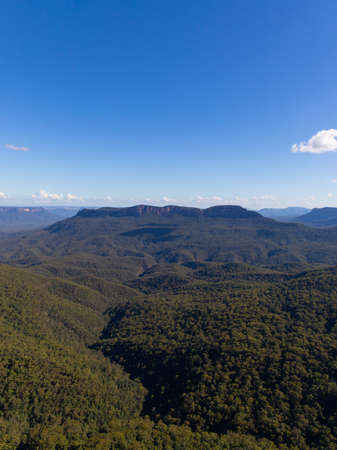 Green hill and mountain view during the day.の写真素材
