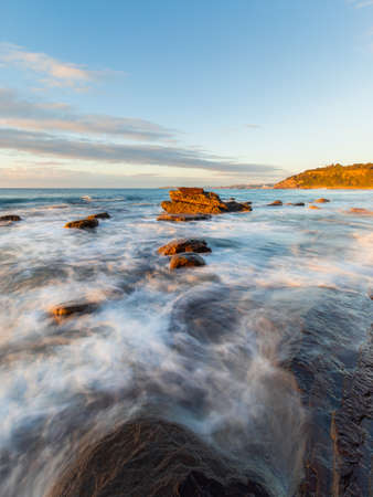 Wave water flowing into the rocky coastline.の写真素材
