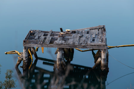 A broken wooden platform on the water.の写真素材