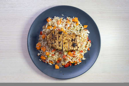 A plate of cajun rice with pork steak on top.の写真素材