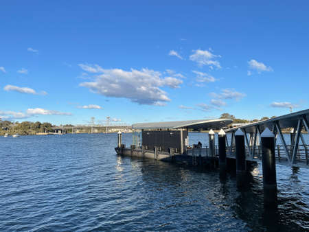 Sydney, Australia - July 25, 2021: Meadowbank Wharf and Ryde Bridge on sunny day.
