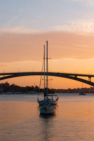 Sydney, Australia - October 8, 2021: Two boats in front of Gladesville Bridge.のeditorial素材
