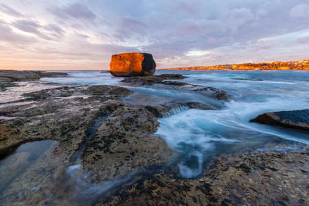 Beautiful sunrise at North Bondi rocks with high tide.の写真素材