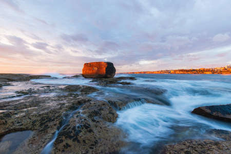 Beautiful sunrise at North Bondi rocks with high tide.の写真素材