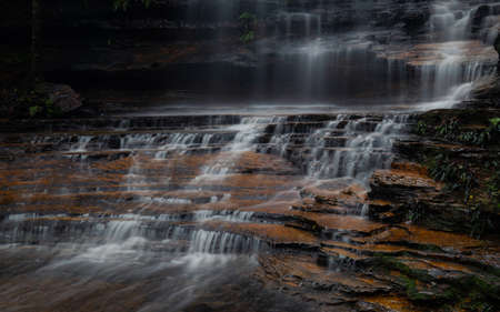 Water flowing on the layer of rocks.の写真素材
