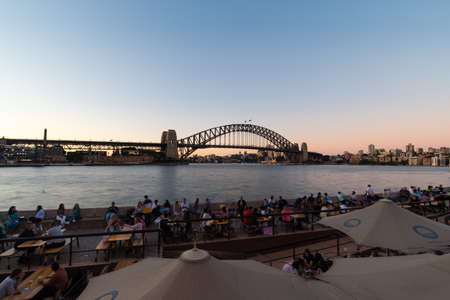 Sydney, Australia - December 29, 2021: Crown of people at Circular Quay with Harbour Bridge on the background.のeditorial素材
