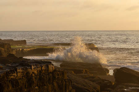 Wave breaking on the rocky coastline.