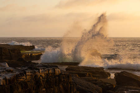 Wave breaking on the rocky coastline.の写真素材