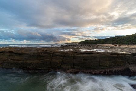 Cloudy view of rocky seascape coastline.の写真素材