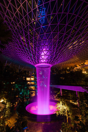 Singapore - May 19, 2022: Jewel Changi Airpot vortex waterfall in purple.のeditorial素材