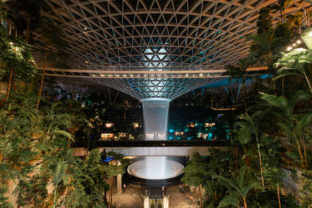 Singapore - May 19, 2022: Indoor urban forest and waterfall at Jewel Changi Airport.のeditorial素材