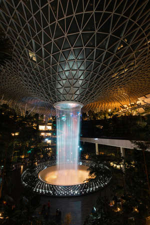 Singapore - May 19, 2022: Night time view of Jewel Changi Airport waterfall vortex.のeditorial素材