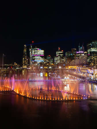 Sydney, Australia - June 8, 2022: Orange and purple fountain show at Darling Harbour for Vivid Sydney.のeditorial素材