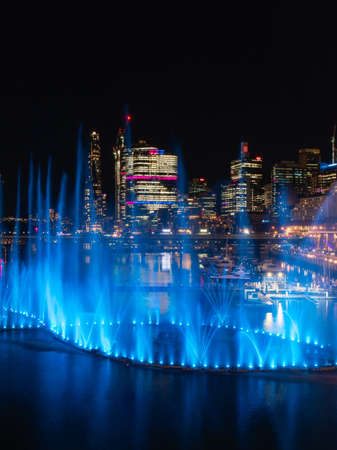Sydney, Australia - June 8, 2022: Blue colored fountain show at Darling Harbour for Vivid Sydney.のeditorial素材