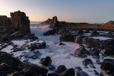 Wave water flowing between rocks at Bombo Quarry, Australia.の写真素材