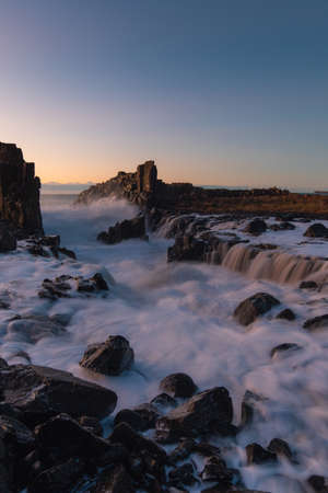 Foamy wave water flowing between rocks at Bombo Quarry, Australia.の写真素材