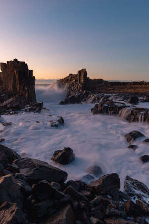 Wave water flowing between rocks at Bombo Quarry, Australia.の写真素材