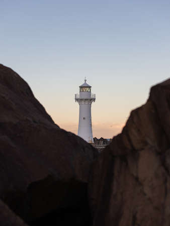 Breakwater lighthouse between rocks, Wollongong, Australia.の写真素材