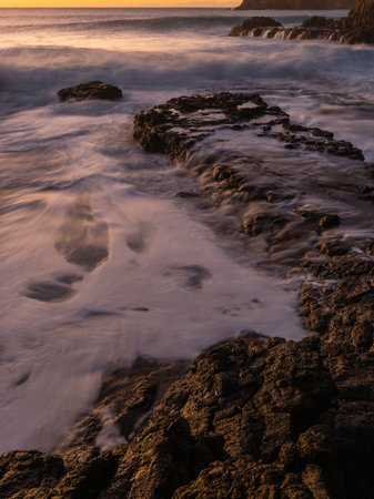 Water flowing on the coastal rock platform.の写真素材